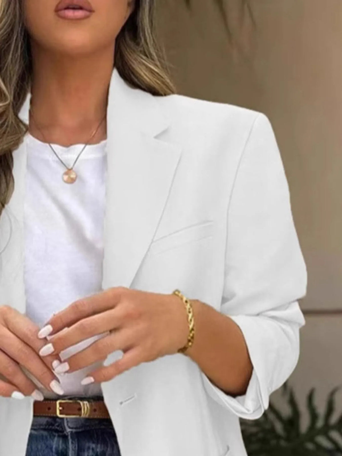 Model wearing a Pocketed Lapel Collar Long Sleeve Blazer with jeans and a stylish handbag.