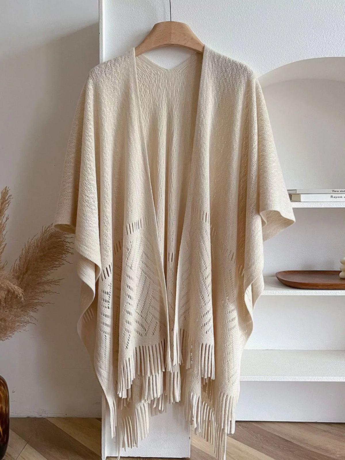 Fringe Open Front Cardigan displayed in a cozy setting, showcasing its soft fabric and stylish fringe details.