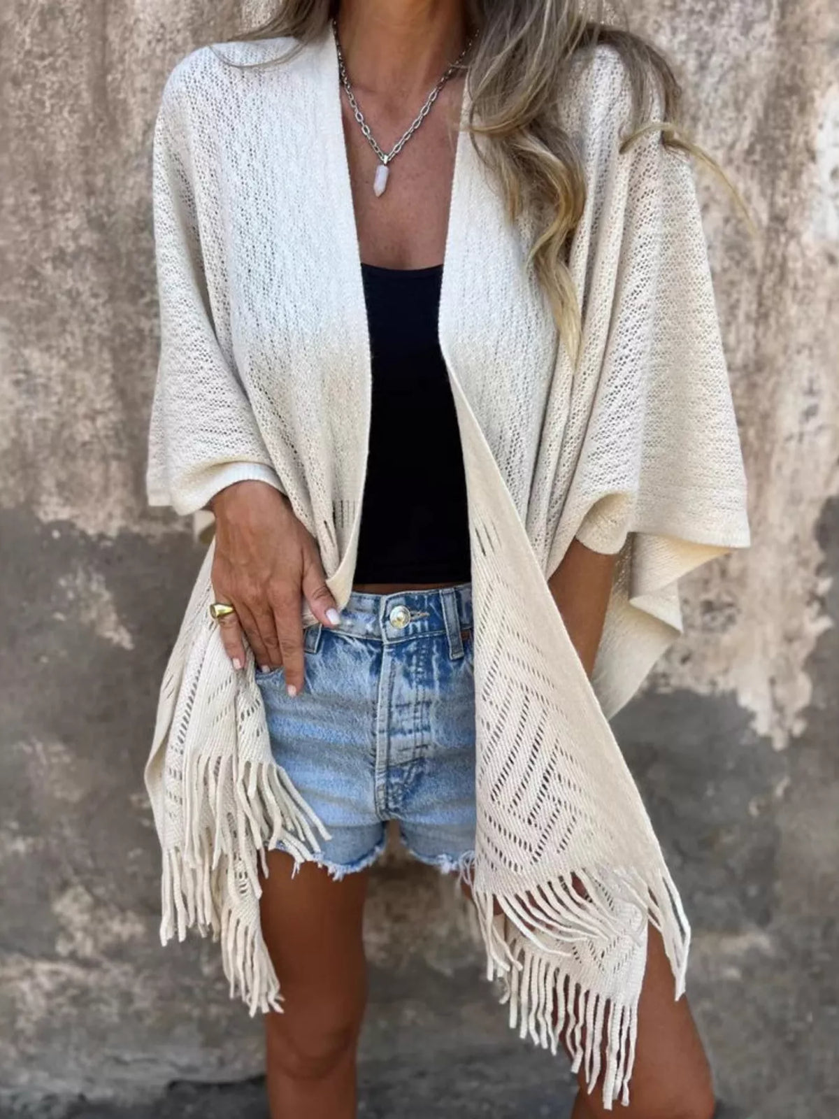 Fringe Open Front Cardigan worn by a woman, styled with denim shorts and a black top, showcasing its chic and comfortable design.