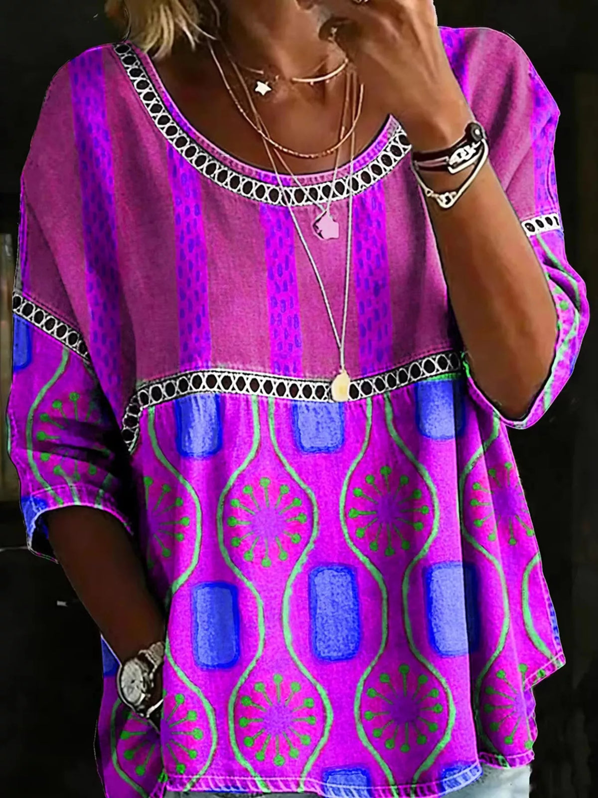 Model wearing a colorful Plus Size Hollow Out Top with chic lace detail in vibrant patterns.