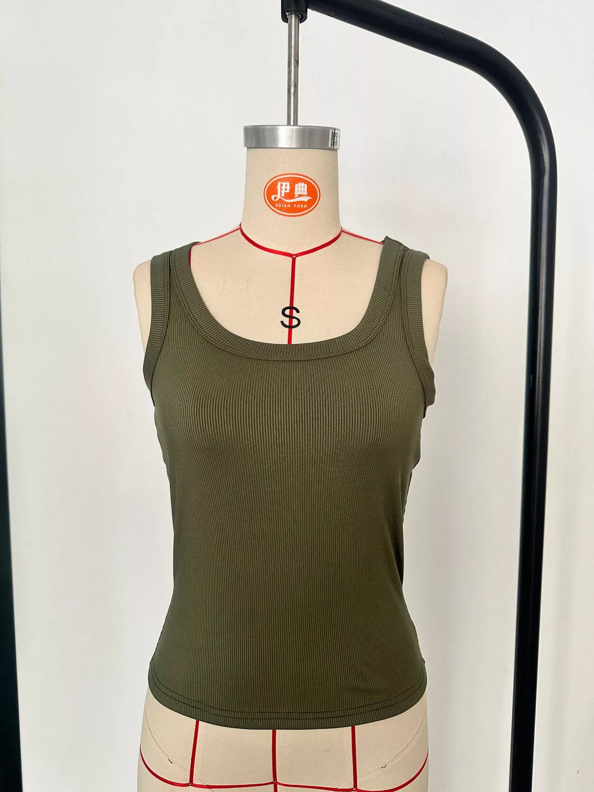 Ribbed Knit Slim Fit Tank Top displayed on a mannequin in olive green, showcasing its stylish and versatile design.