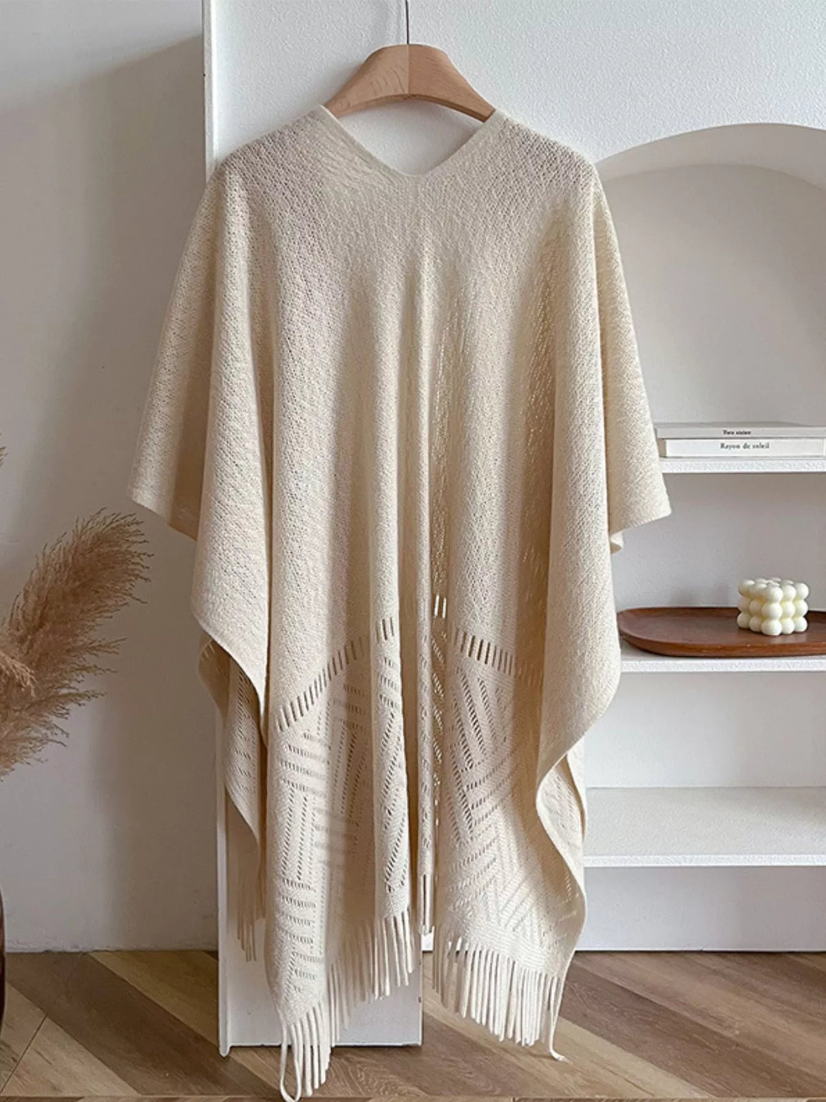 Fringe Open Front Cardigan displayed in a cozy setting, showcasing its soft fabric and stylish fringe details.