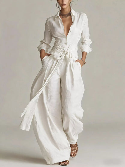 Back view of a woman wearing a Long-Sleeve Waist-Tie Jumpsuit in brown, showcasing its elegant design.