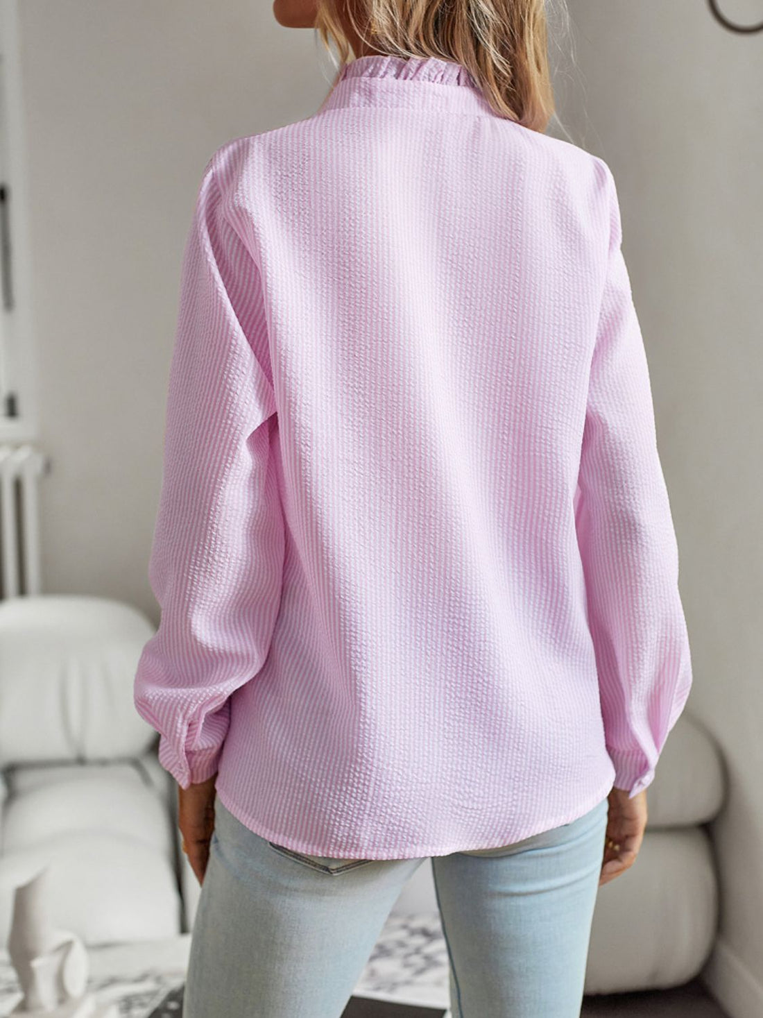Back view of a woman wearing the Devine Ruffle Trim Long Sleeve Shirt in pink, showcasing its elegance and ruffle detailing.