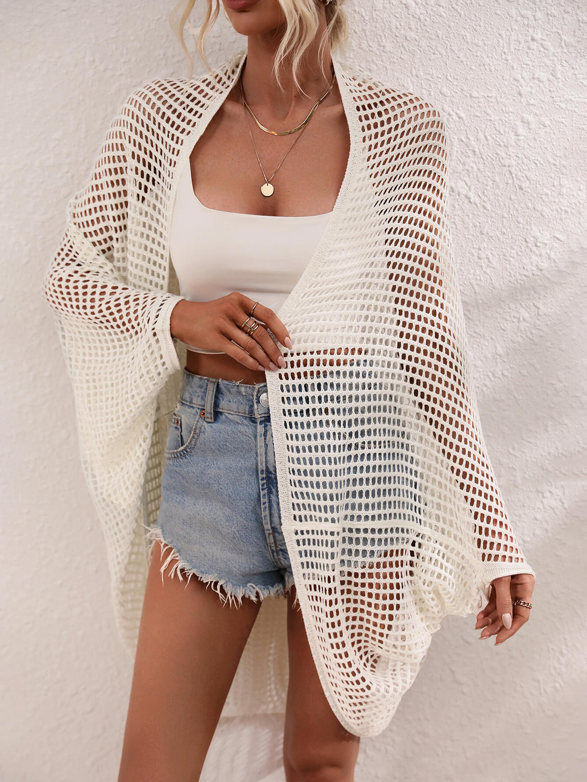 Openwork Longline Cover Up worn over a crop top and shorts, showcasing its stylish sheer design.