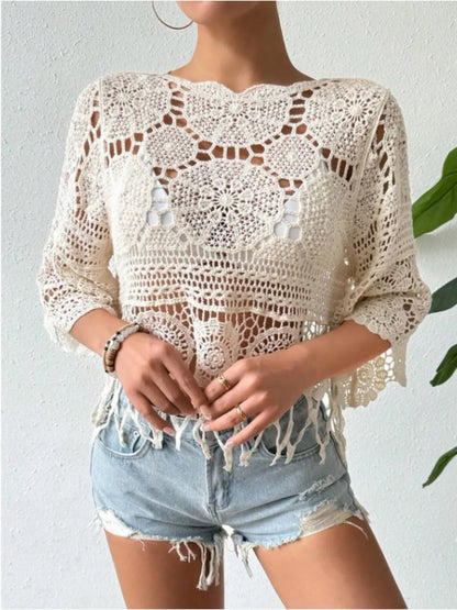 Model showcasing an openwork round neck cover-up paired with denim shorts, perfect for summer styling.