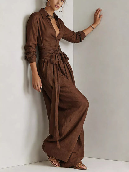 Back view of a woman wearing a Long-Sleeve Waist-Tie Jumpsuit in brown, showcasing its elegant design.