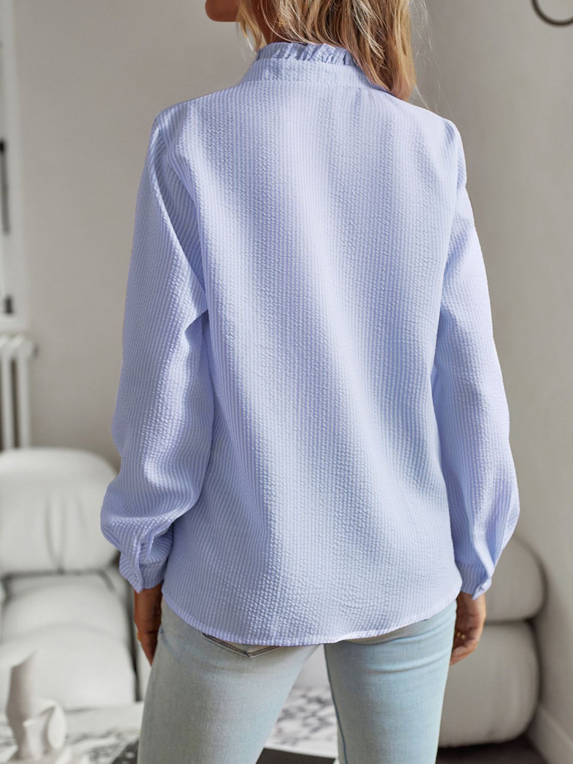 Back view of the Devine Ruffle Trim Long Sleeve Shirt in light blue, showcasing ruffle detailing and casual style.