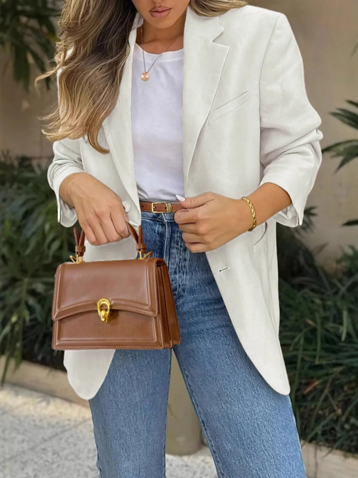 Model wearing a Pocketed Lapel Collar Long Sleeve Blazer with jeans and a stylish handbag.