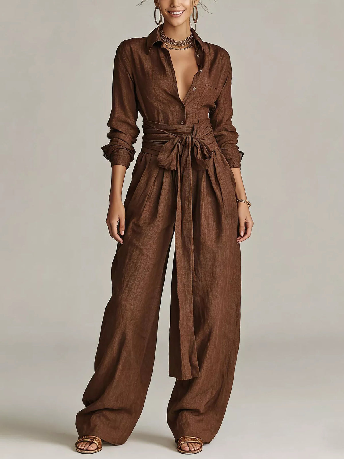 Back view of a woman wearing a Long-Sleeve Waist-Tie Jumpsuit in brown, showcasing its elegant design.
