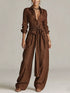 Back view of a woman wearing a Long-Sleeve Waist-Tie Jumpsuit in brown, showcasing its elegant design.