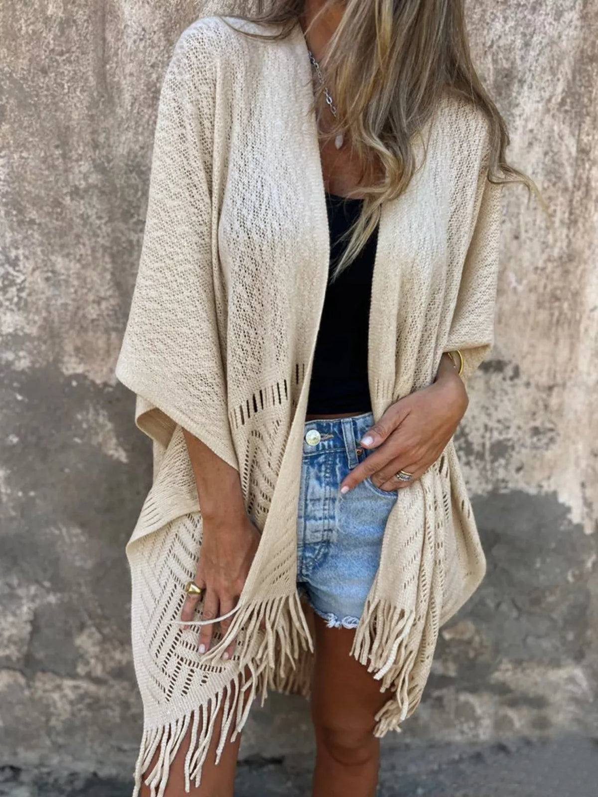 Fringe Open Front Cardigan worn by a woman, styled with denim shorts and a black top, showcasing its chic and comfortable design.