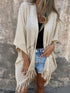 Fringe Open Front Cardigan worn by a woman, styled with denim shorts and a black top, showcasing its chic and comfortable design.