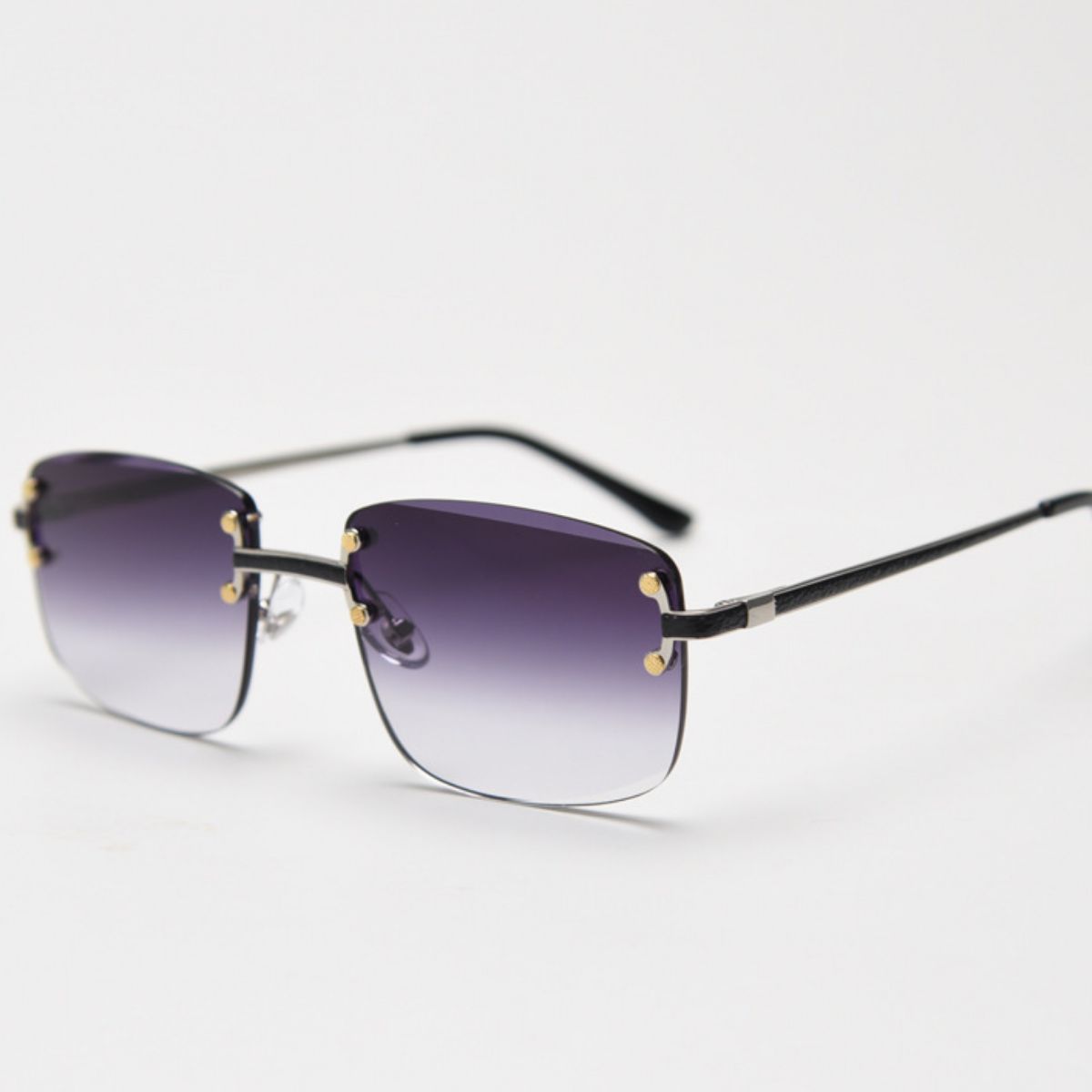 Rimless Gradient Tinted Sunglasses worn by a woman with dark hair and pearl earrings