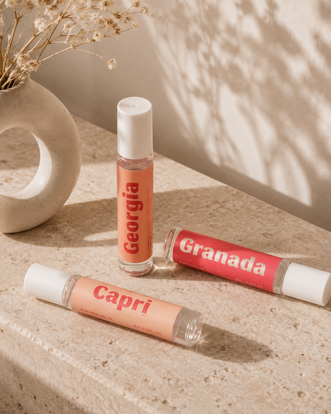Summer Paradise Perfume Trio featuring Georgia, Granada, and Capri roll-on scents elegantly displayed.