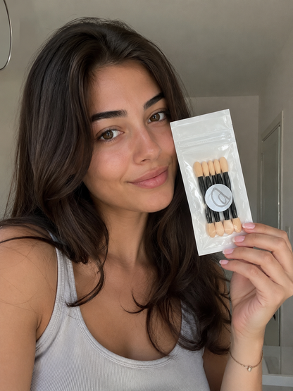 Professional eyeshadow applicators in a clear package held by a smiling woman, ideal for enhancing makeup application.