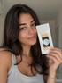 Professional eyeshadow applicators in a clear package held by a smiling woman, ideal for enhancing makeup application.