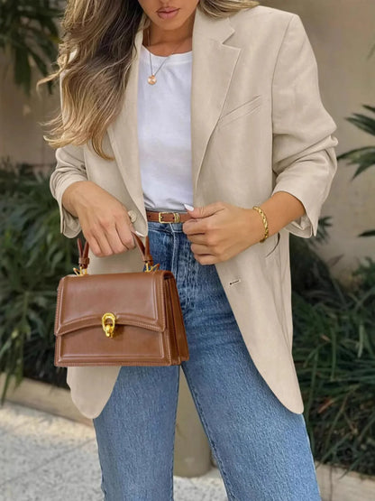 Model wearing a Pocketed Lapel Collar Long Sleeve Blazer with jeans and a stylish handbag.