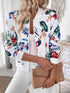 Printed Zip Up Jacket featuring vibrant floral print, styled with casual white outfit and clutch bag.