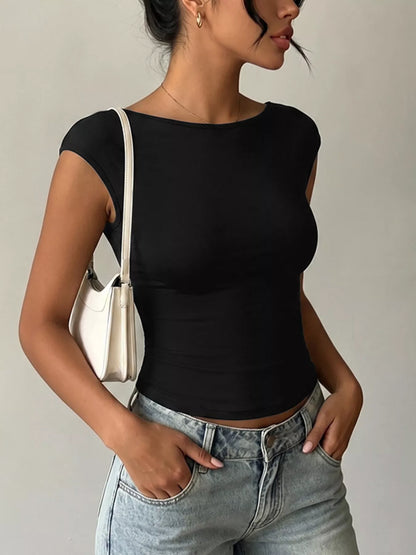 Model wearing a Lace Detail Cap-Sleeve T-Shirt with a black design and casual jeans.