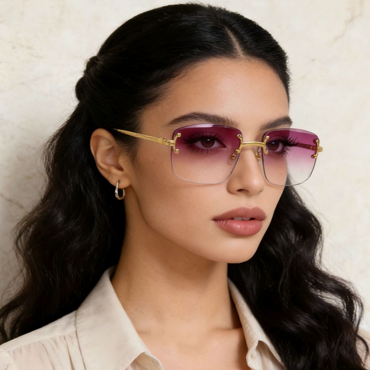 Rimless Gradient Tinted Sunglasses worn by a woman with dark hair and pearl earrings