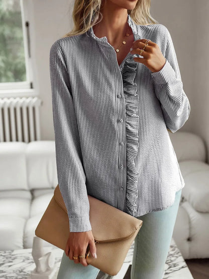 Devine Ruffle Trim Long Sleeve Shirt, stylish blouse with ruffle detail, worn with clutch in casual setting.