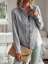 Devine Ruffle Trim Long Sleeve Shirt, stylish blouse with ruffle detail, worn with clutch in casual setting.