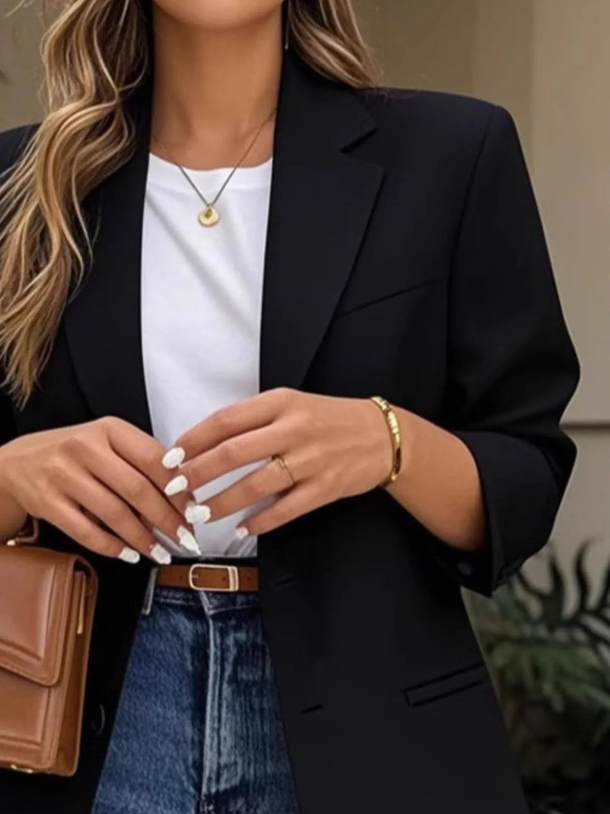 Model wearing a Pocketed Lapel Collar Long Sleeve Blazer with jeans and a stylish handbag.