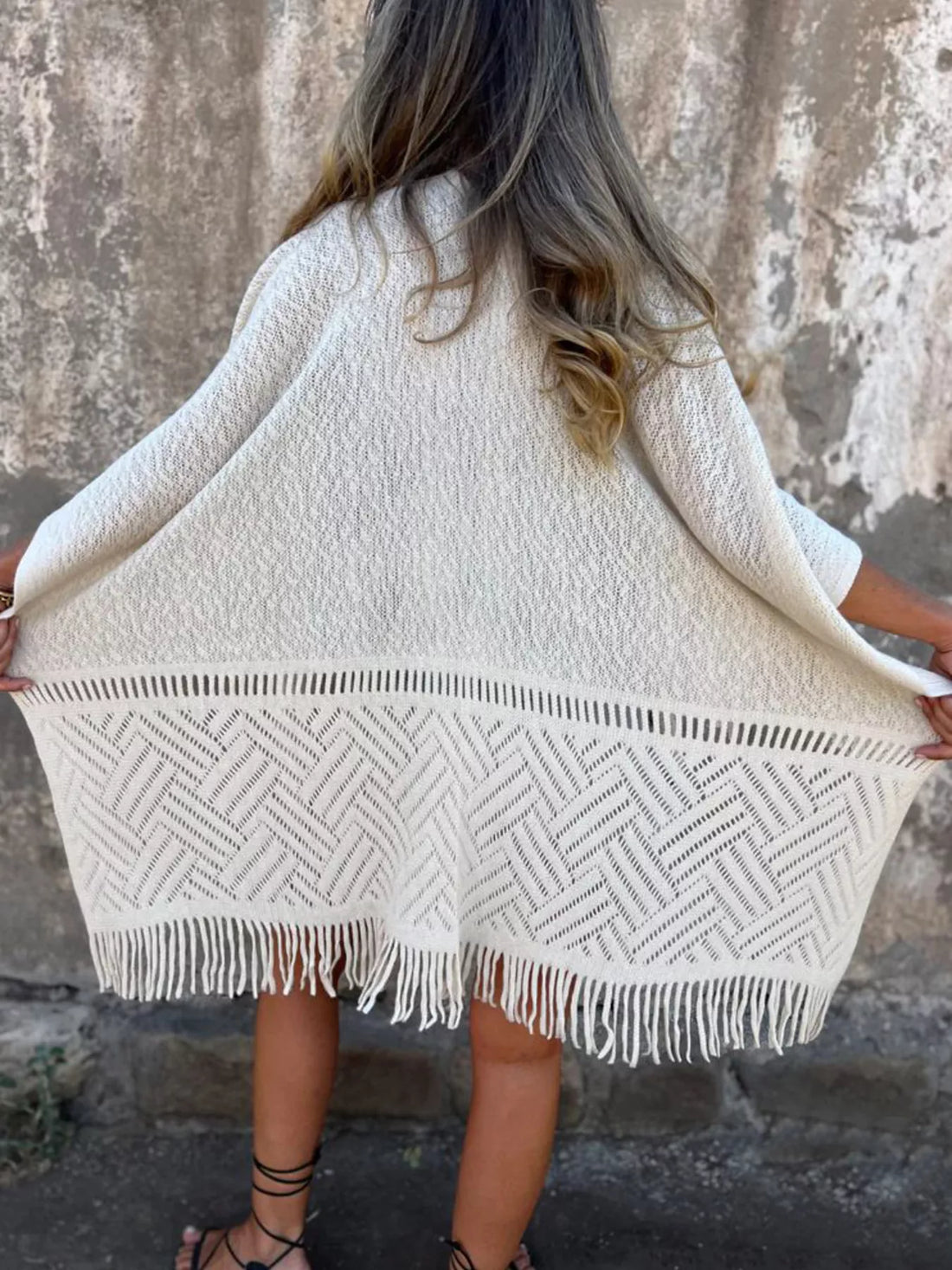Fringe Open Front Cardigan worn by a woman, styled with denim shorts and a black top, showcasing its chic and comfortable design.
