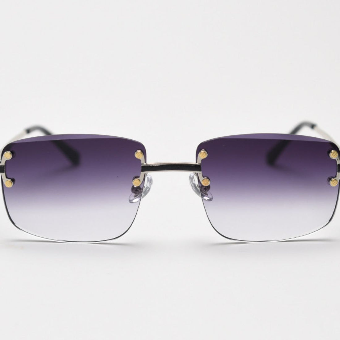 Rimless Gradient Tinted Sunglasses worn by a woman with dark hair and pearl earrings