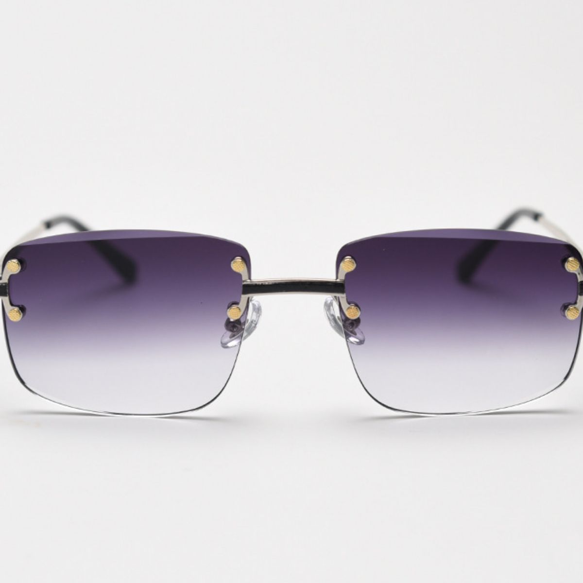 Rimless Gradient Tinted Sunglasses worn by a woman with dark hair and pearl earrings
