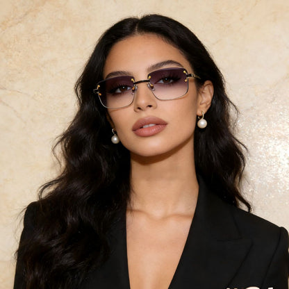 Rimless Gradient Tinted Sunglasses worn by a woman with dark hair and pearl earrings