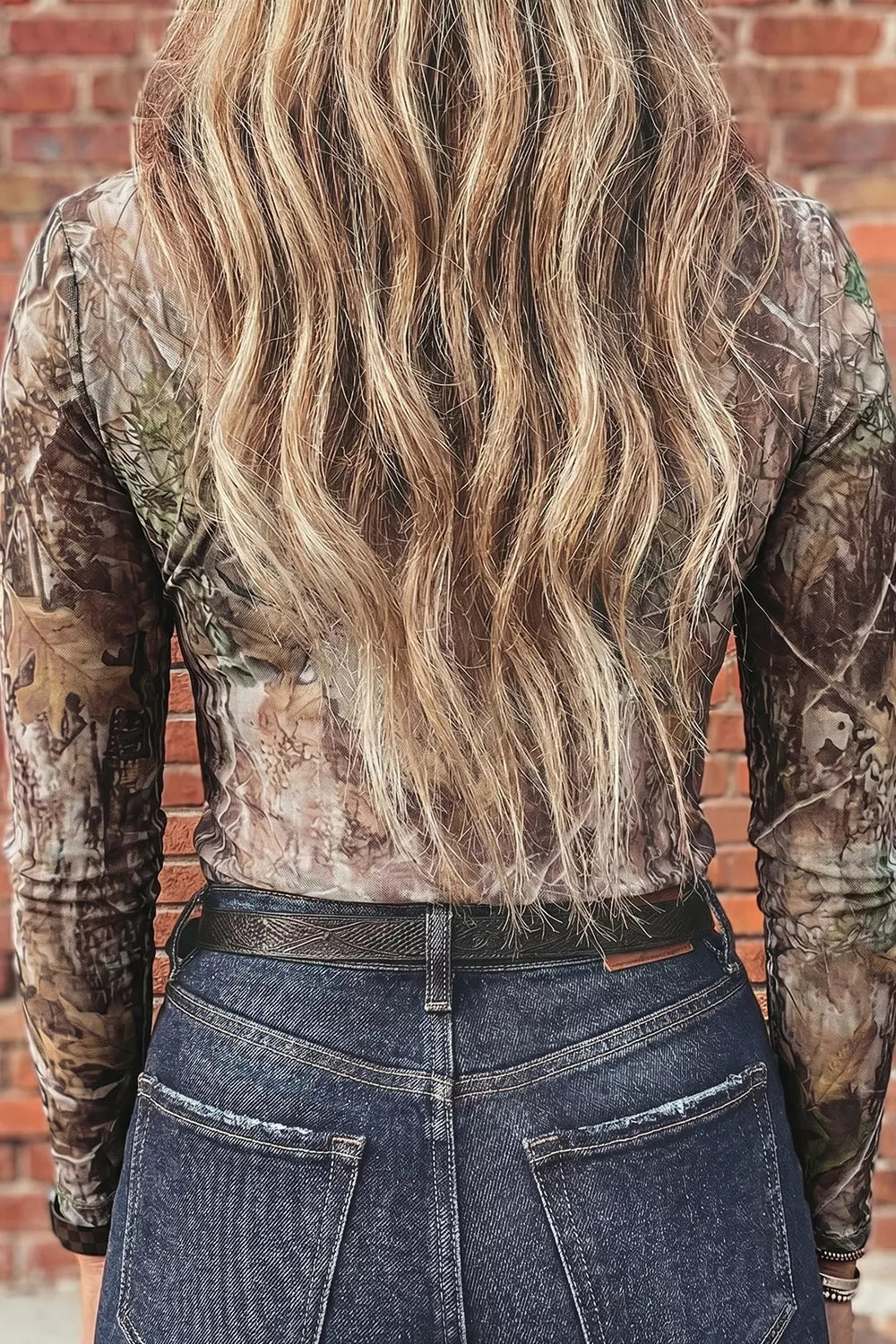 Mock Neck Long Sleeve Mesh Top worn by a woman with layered necklaces and stylish jeans against a rustic background.