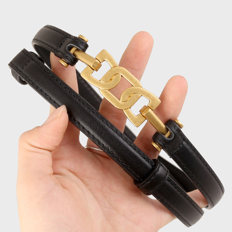 Gold Buckle Skinny Leather Belt showcased in black leather with a stylish gold buckle design.